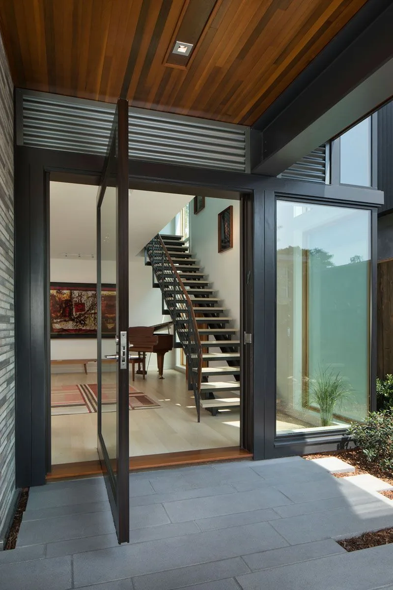 Modern glass door in a contemporary home by Zenith Glass and Mirror, enhancing natural light and elegance.