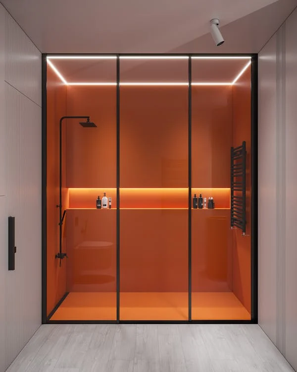 Modern shower glass enclosure with black frame and LED lighting